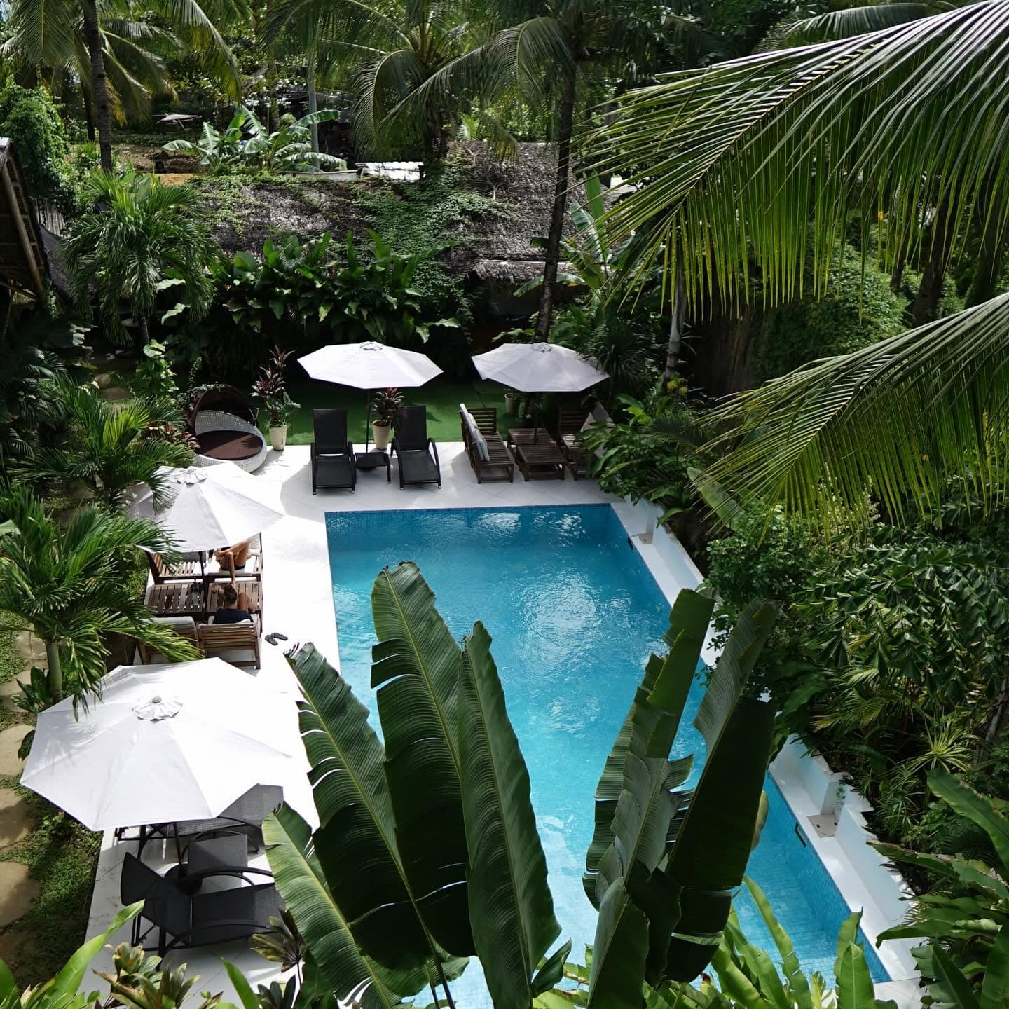 Room overlooking the outdoor pool and tropical garden at Villa Cali Siargao